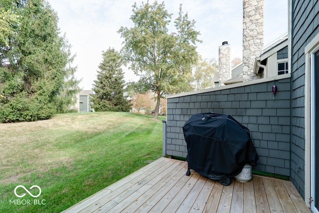 wooden terrace with a yard and grilling area