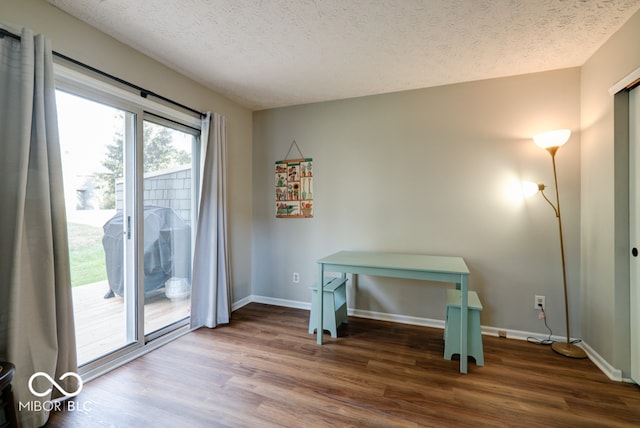 interior space with a textured ceiling and hardwood / wood-style flooring