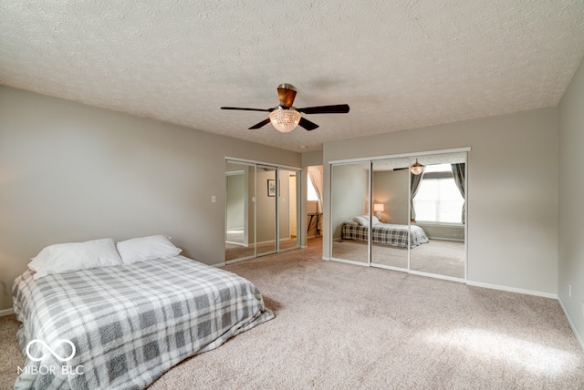 bedroom featuring carpet floors, a textured ceiling, and ceiling fan