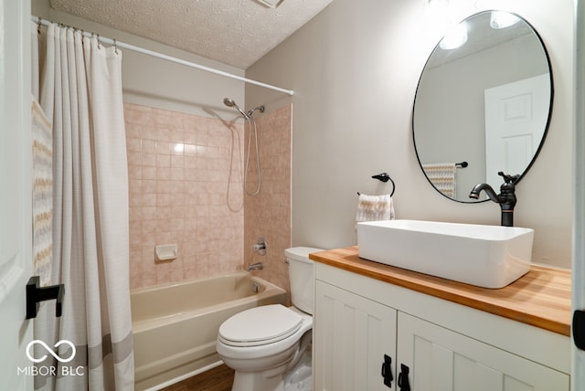 full bathroom with vanity, a textured ceiling, toilet, and shower / bathtub combination with curtain