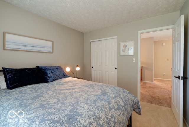 carpeted bedroom featuring a closet and a textured ceiling