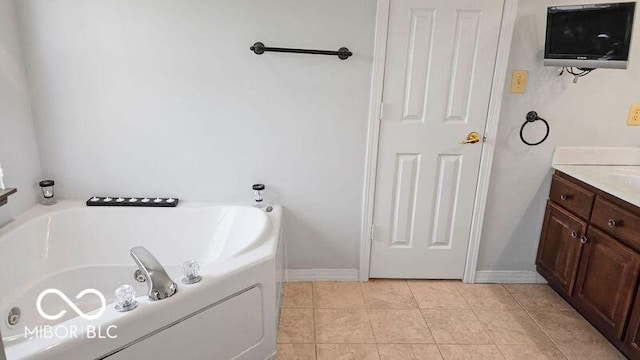 bathroom with vanity, a bath, and tile patterned floors