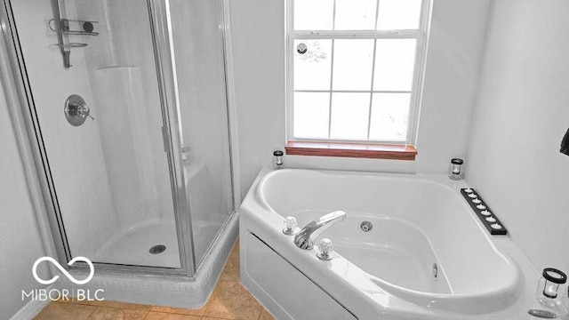 bathroom featuring tile patterned floors and shower with separate bathtub