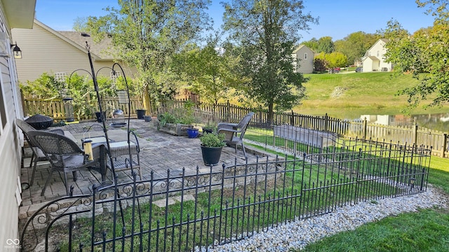 view of yard with a water view and a patio area