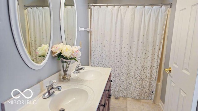 bathroom featuring vanity, shower / bath combo with shower curtain, and tile patterned flooring