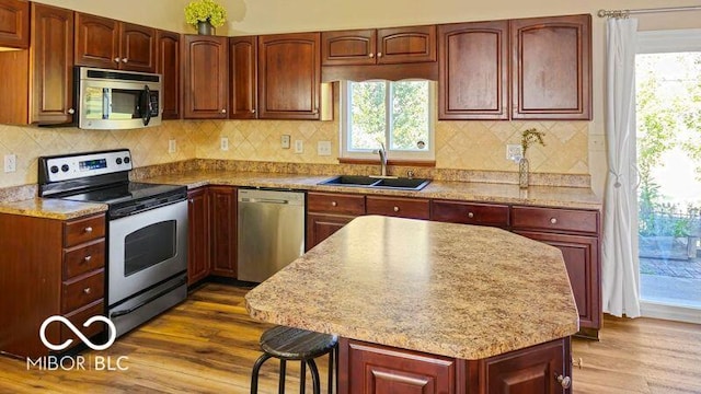 kitchen featuring stainless steel appliances, dark wood-type flooring, and plenty of natural light