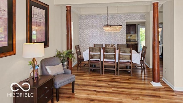 dining area featuring light hardwood / wood-style flooring and a chandelier