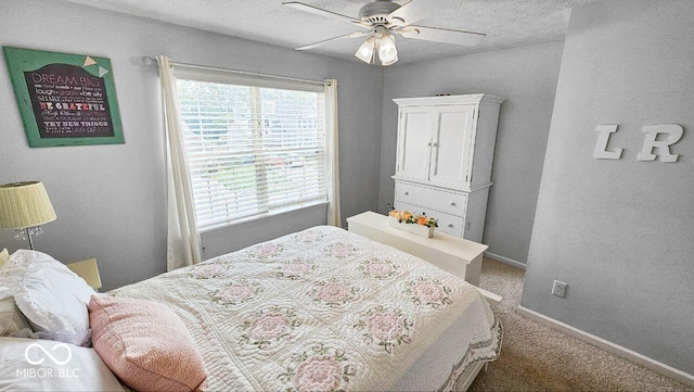 carpeted bedroom with ceiling fan and a textured ceiling