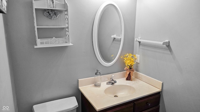 bathroom featuring toilet and vanity