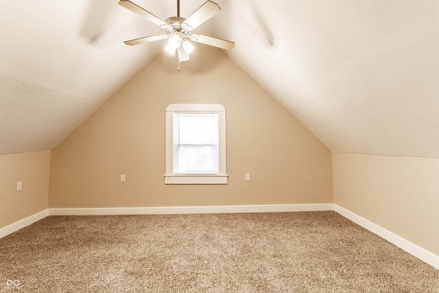 bonus room featuring lofted ceiling, carpet, and ceiling fan