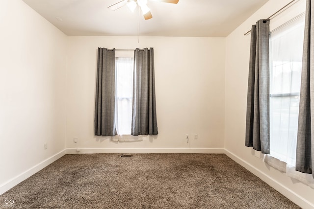 carpeted spare room featuring ceiling fan