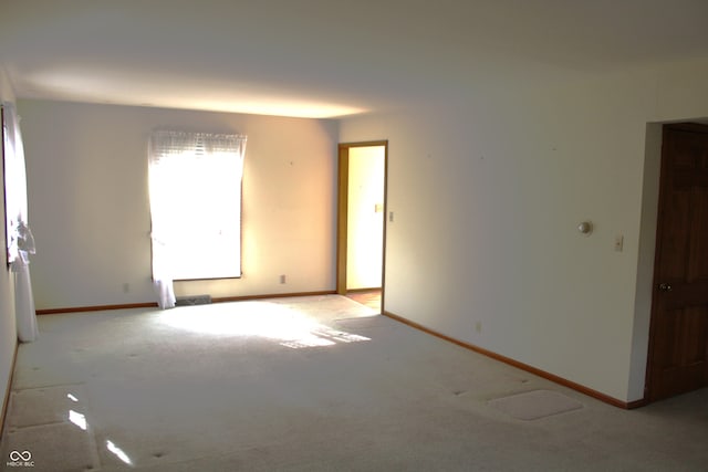 unfurnished room with light colored carpet