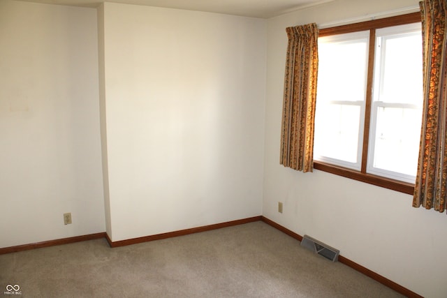 empty room featuring a healthy amount of sunlight and carpet