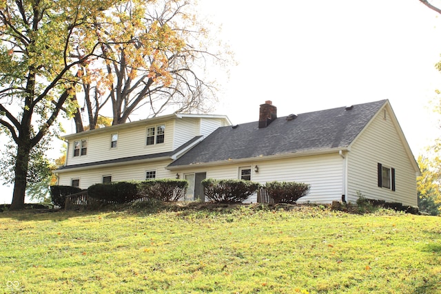 rear view of property with a yard