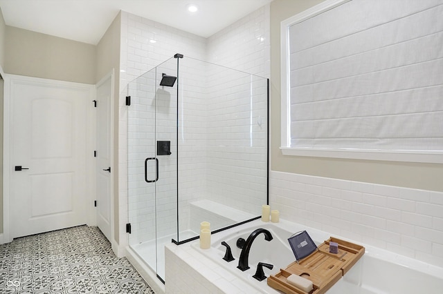 bathroom with separate shower and tub