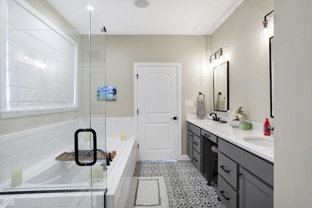 bathroom featuring independent shower and bath and vanity