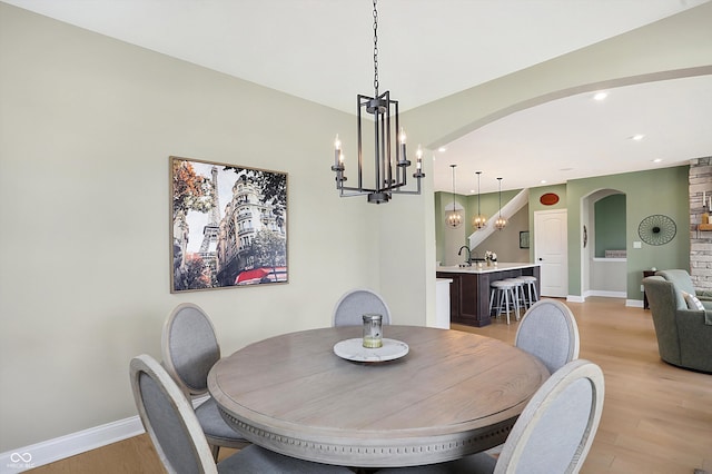 dining area featuring sink and light hardwood / wood-style flooring