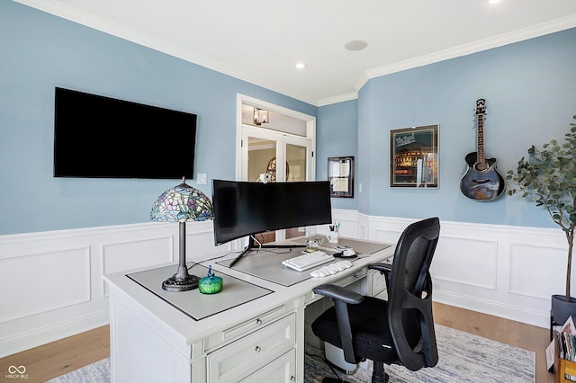 office with light hardwood / wood-style floors and ornamental molding