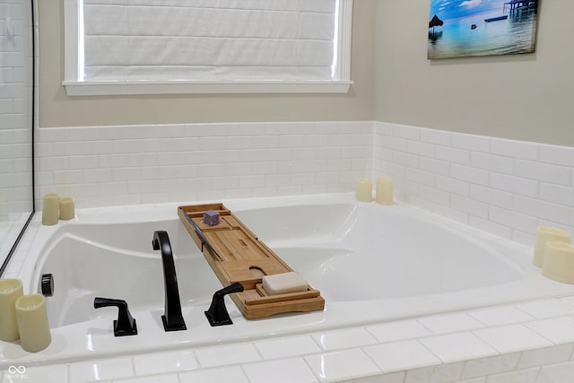 bathroom with tiled bath