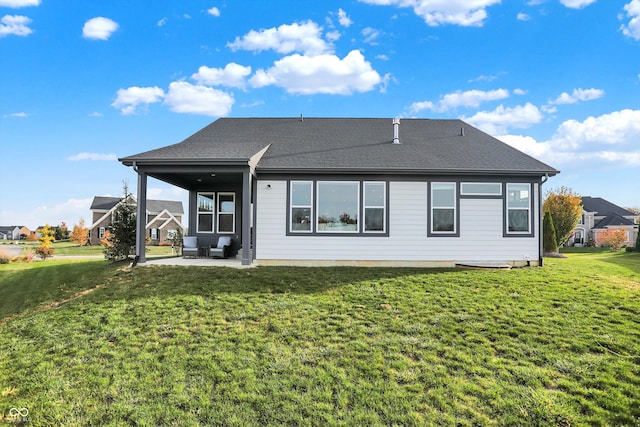 rear view of property with a lawn and a patio area