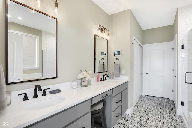 bathroom with walk in shower, vanity, and tile patterned floors