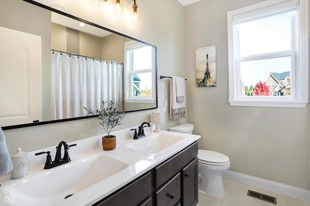 bathroom featuring tile patterned floors, vanity, and toilet