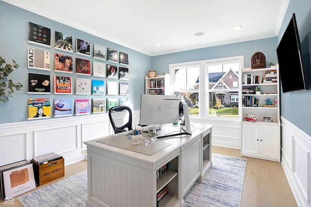 home office with light wood-type flooring and crown molding