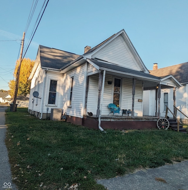 bungalow-style house with a porch and a front lawn