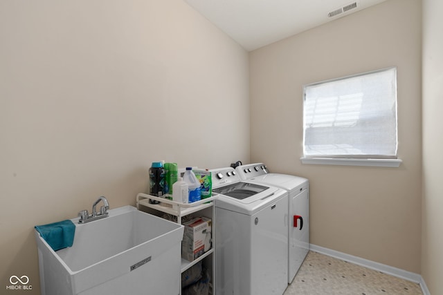 washroom with sink and washing machine and clothes dryer