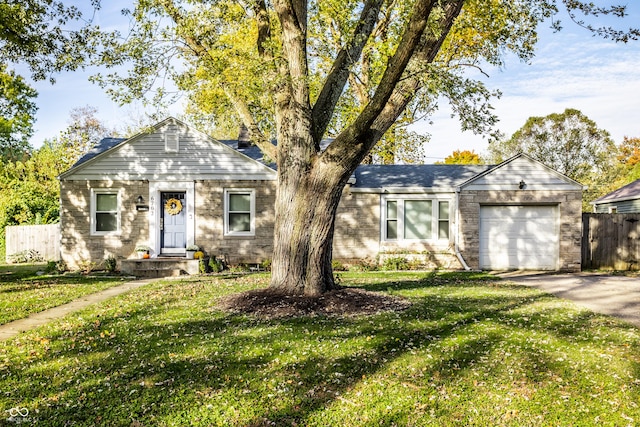 ranch-style home with a garage and a front lawn