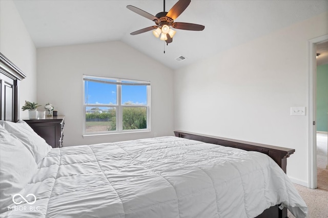 carpeted bedroom with vaulted ceiling and ceiling fan