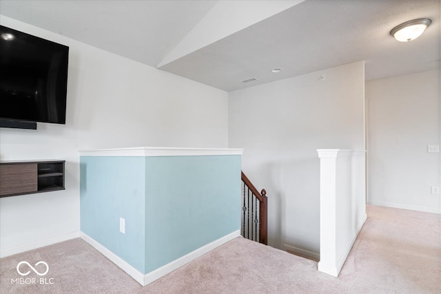 hallway featuring light colored carpet