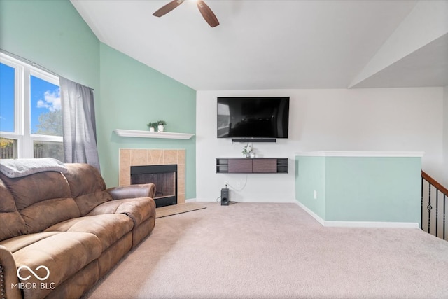 living room with ceiling fan, carpet flooring, lofted ceiling, and a fireplace