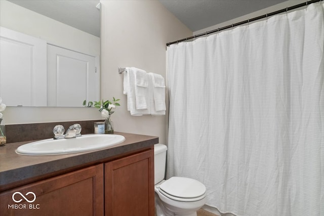 bathroom with vanity, toilet, and curtained shower