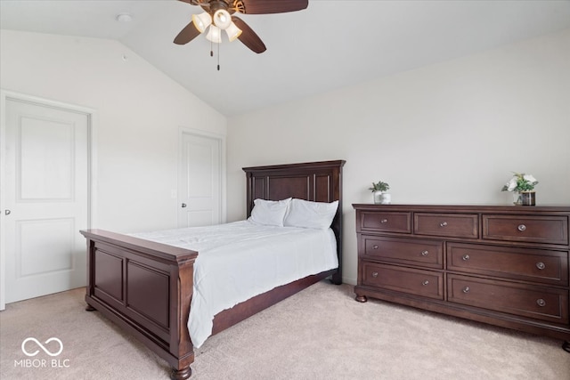 bedroom featuring ceiling fan, light colored carpet, and vaulted ceiling