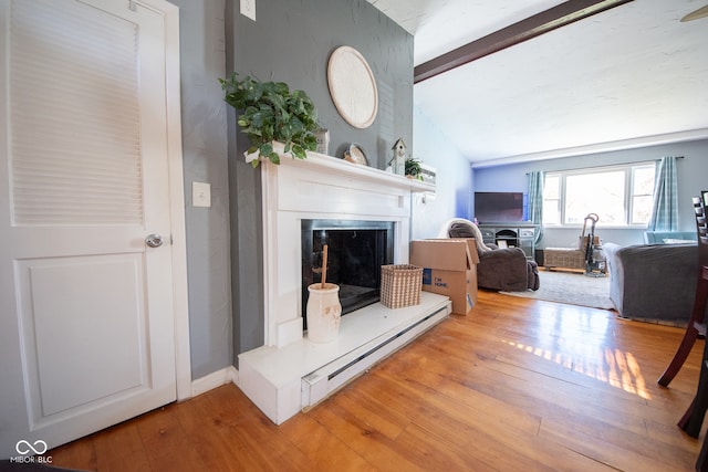 living room with baseboard heating, light hardwood / wood-style flooring, and vaulted ceiling with beams