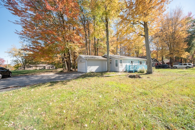 view of front of property with a front yard, a garage, and a porch