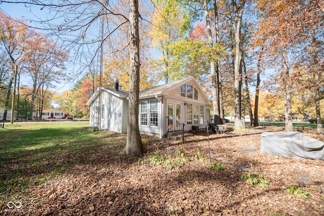 view of side of property with a lawn