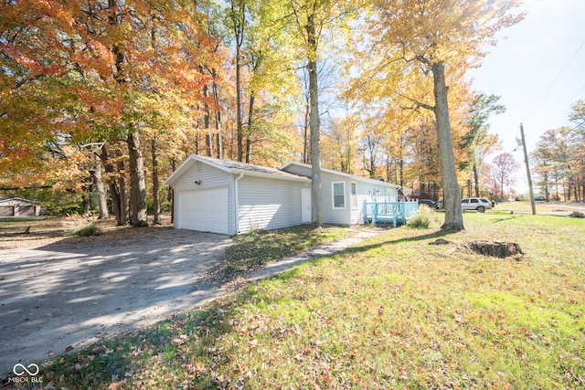 view of front of house with a front lawn, a garage, an outdoor structure, and a wooden deck