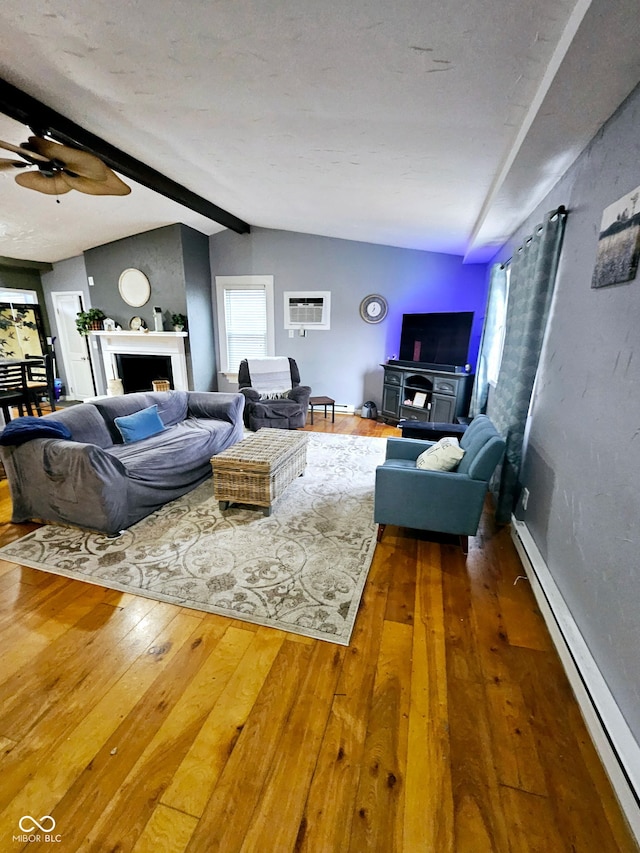 living room featuring plenty of natural light, lofted ceiling with beams, a baseboard radiator, and hardwood / wood-style floors