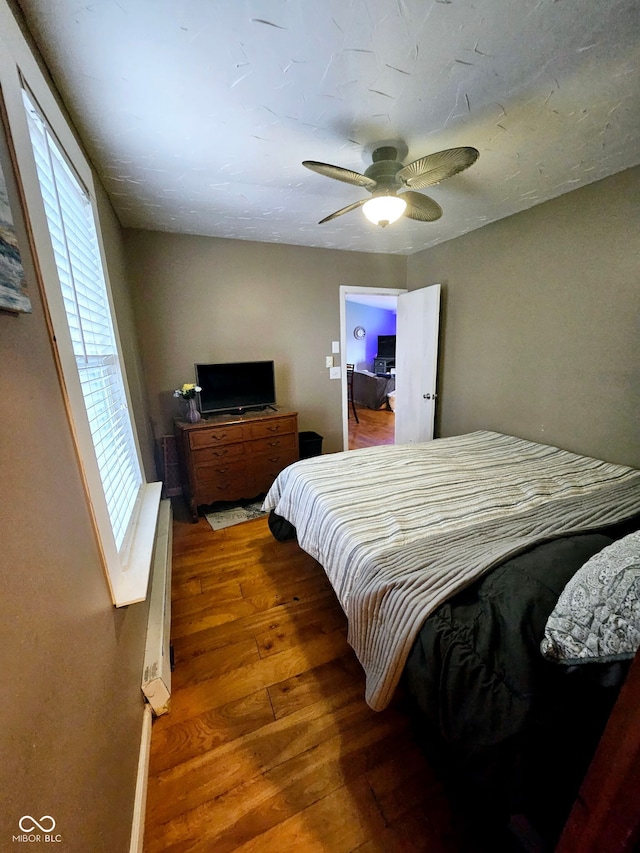 bedroom with ceiling fan and wood-type flooring