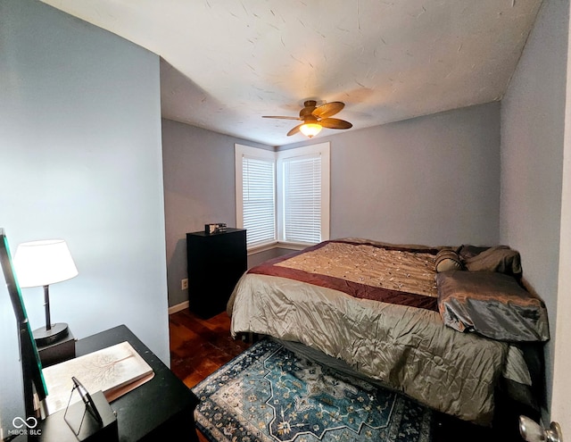 bedroom featuring ceiling fan and dark wood-type flooring