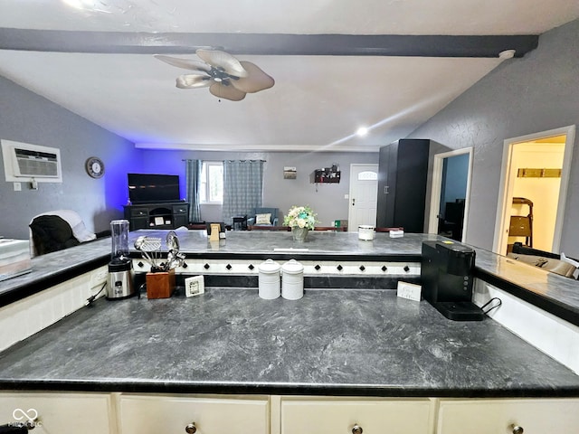 kitchen with white cabinetry, a wall mounted AC, vaulted ceiling with beams, and ceiling fan