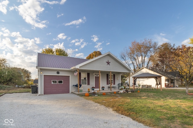 ranch-style home with a gazebo, a front yard, a garage, and covered porch