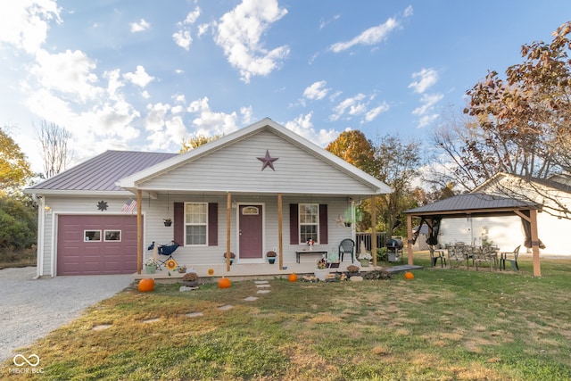 view of front facade featuring a gazebo, covered porch, a front yard, and a garage