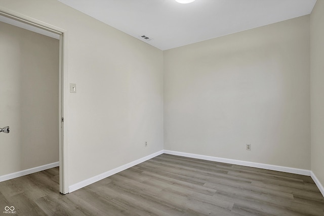 spare room with hardwood / wood-style floors