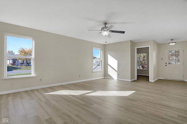 unfurnished living room featuring light hardwood / wood-style floors, plenty of natural light, and ceiling fan