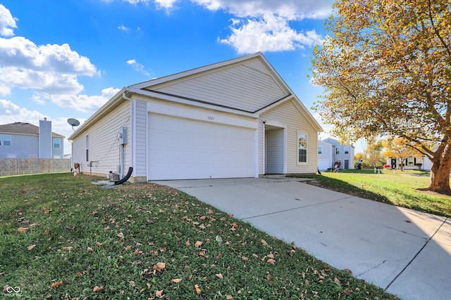 view of side of property featuring a garage and a lawn