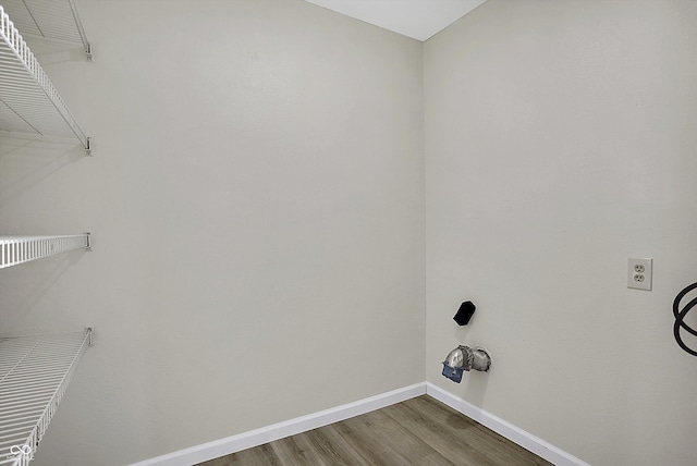 clothes washing area featuring hookup for a washing machine and hardwood / wood-style floors