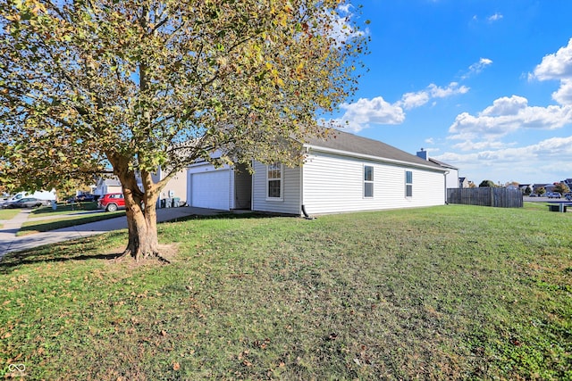 view of property exterior with a yard and a garage